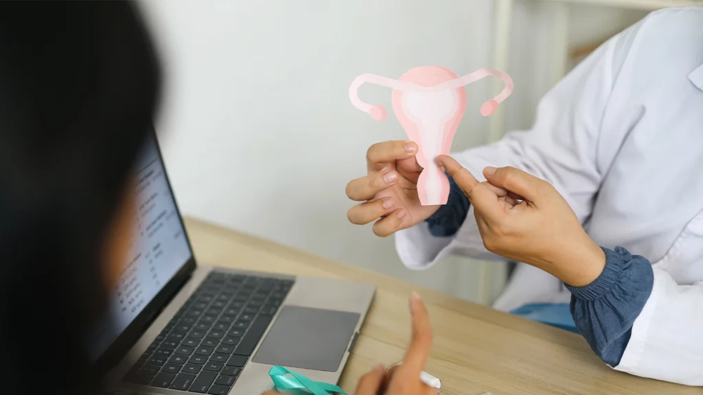 Doctor explains uterus diagram to patient in office