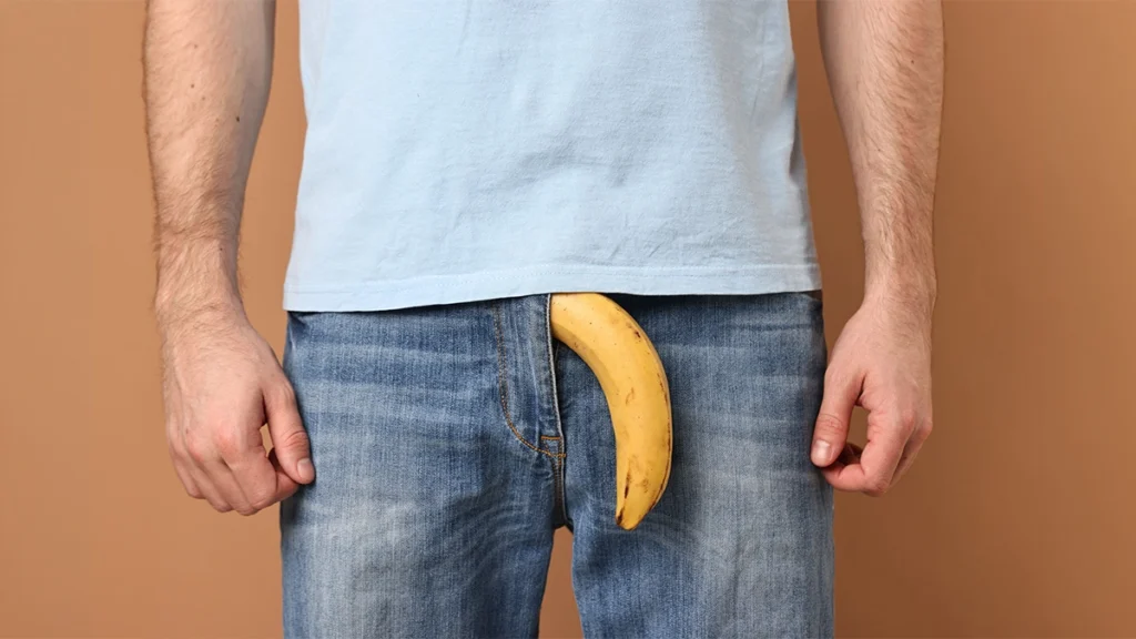 Man standing with a banana in the zipper of his jeans